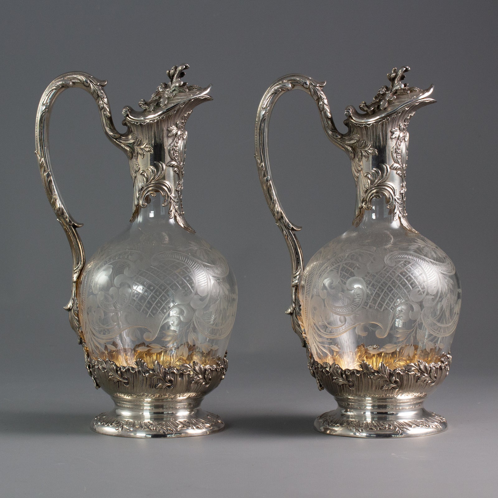 A Pair of Late 19th Century French Silver and Crystal Claret Jugs