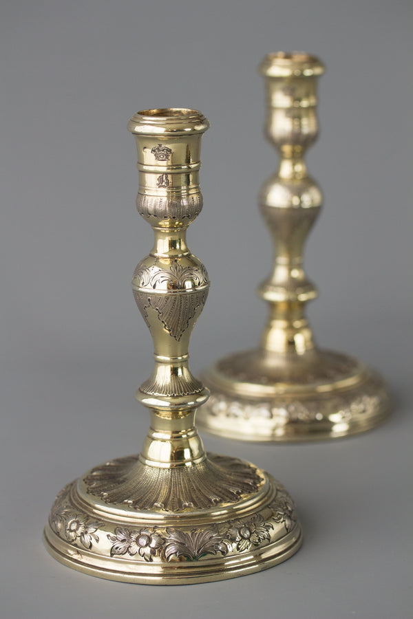 An Elegant Pair of Queen Anne/George I Silver-Gilt Cast Candlesticks by Matthew Cooper